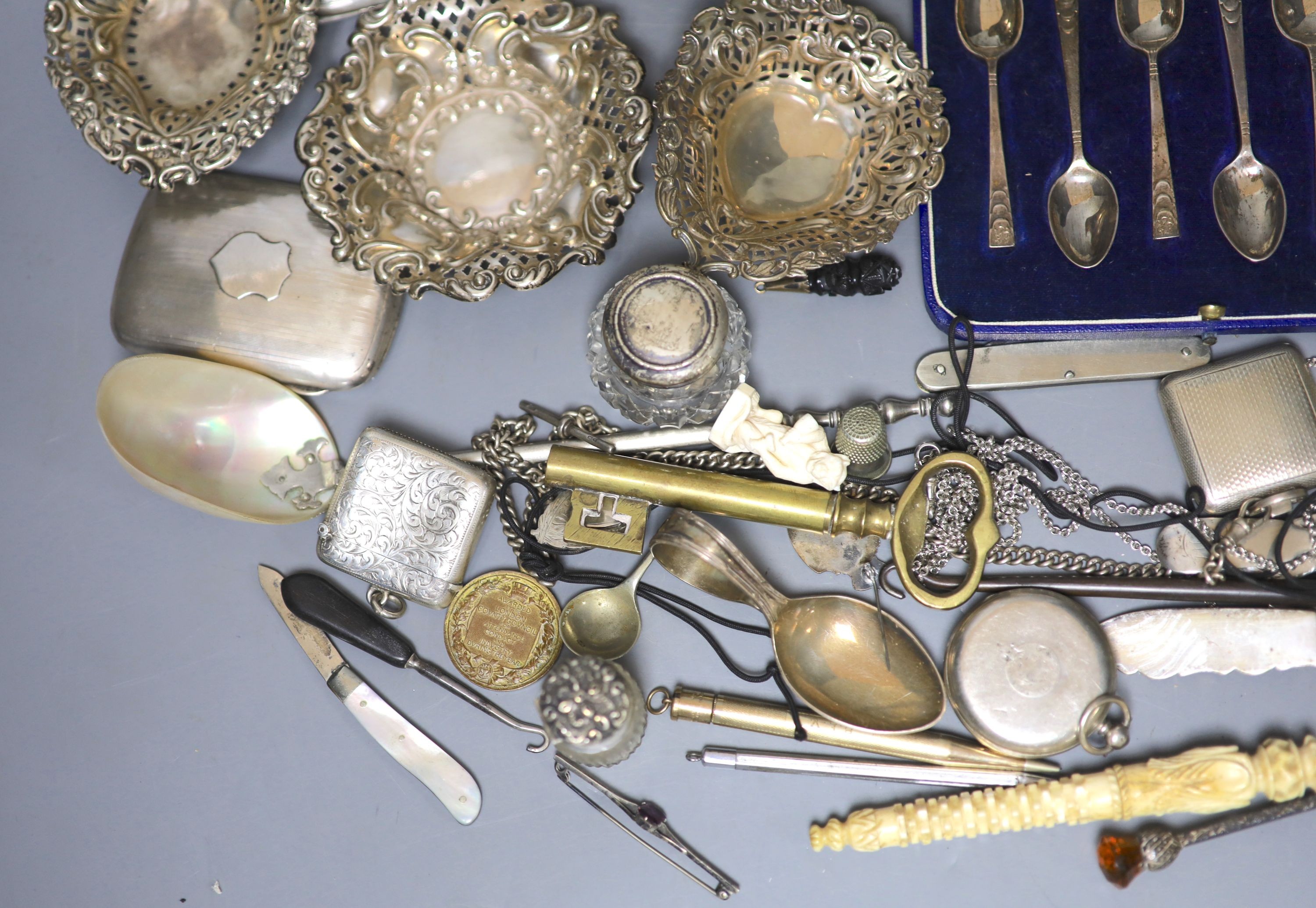 Mixed small silver and other collectable including a cased set of silver silver coffee spoons, a George III silver cream jug, bonbon dishes, cigarette cases, vesta case, flatware, scent bottles, a cold painted bronze bir